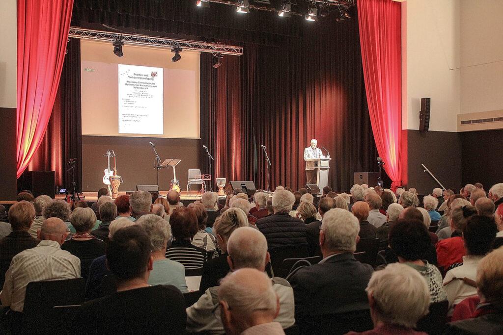 431302 OKV Saal - Nicht dumm machen lassen - Alternative Einheitsfeier, BSW, deutscher Imperialismus, Kriegslügen, Ostdeutsches Kuratorium von Verbänden e. V., Sevim Dagdelen - Hintergrund